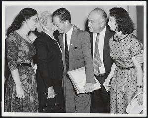 Welcome Home, Boy-George Abrams, Harvard law school graduate who told the Russians the facts of life in Moscow, is kissed by his mother, Mrs. Samuel Abrams of Newton, as he arrives at Boston airport. Also on hand are, left to right, Susan Abrams, father Samuel Abrams, and sister Ruth Abrams, far right.