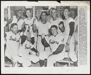 Jubilation in the Wigwam--Cleveland Indians manager Al Lopez (seated) joins with some of the team in a cheer after they defeated the Philadelphia A's 5-3 to go ahead of the New York Yankees by five and one-half games. L to R front, Riggie Regalado, Bob Lemon, Lopez. Back Row L to R, Al Smith, Bill Glyn, Bobby Avila, Bob Feller, Al Rosen and Catcher Hal Naragon. The winning run was walked across in the eleventh inning.