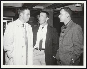 What to do, three members of the Kansas City A’s, Frank House, Bill Tuttle, and Joe DeMaestri (left to right) huddle in Hotel Kenmore lobby try to decide what movie to take in while waiting for today’s date with Sox.
