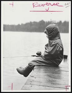 Four-Year-Old Roger Gauthier of Wenham plays a waiting game at Pleasant Pond.