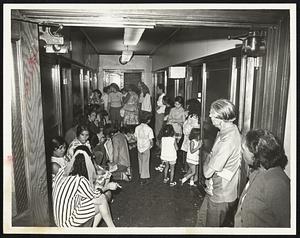 Spanish-Speaking welfare recipients crowd corridor of Uphams Corner, Dorchester, welfare office to demand home furnishings.