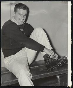 No, This is Not a Bargain Basement - Ernie Schwotzer (left) trying on the shoes, and [Alex] Lukachik trying on the jersey with the assistance of Chet Gladchuk, merely want to make sure they get the right size in their football equipment.