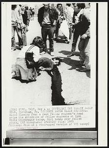 Students Watch Slain Student-- Blood flowing from a dead fellow student's head grips the attention of fellow students at Kent State University today. Girl bends over fallen youth.