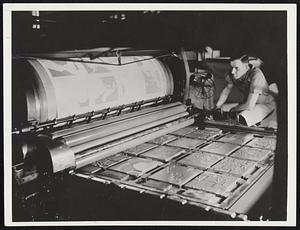 "Rolling" a map color form on a flat bed press. The plates pictured here have been made by the wax engraving process. In many cases only a portion of a map is corrected. This portion or "patch," as it is called, is made by this process and when completed is inserted into the existing map plate, thus bringing the map up to date.