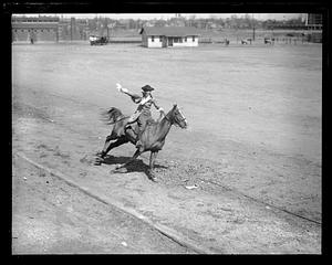 A man in colonial dress riding a horse