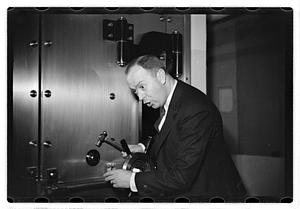 A man demonstrating how to break into a safe