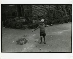 Shirtless boy holding his arms out