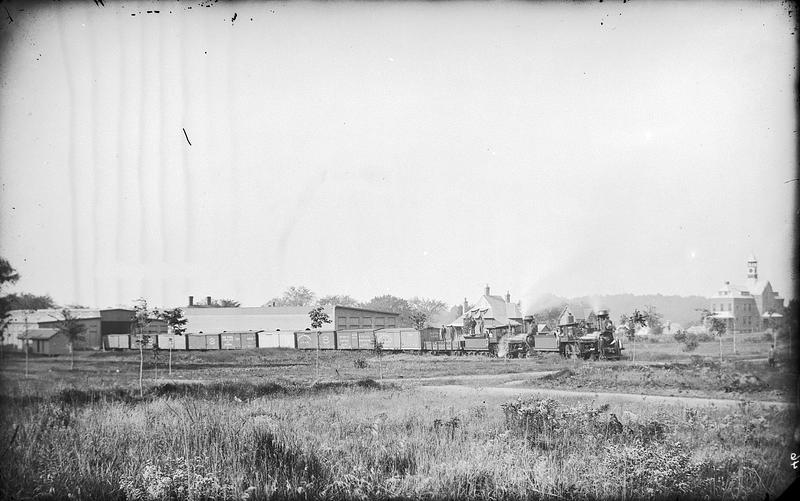 (Train) crossing Windsor Street with men standing on train