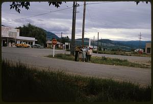 People standing by Sexsmith Rd. street sign, Kelowna, British Columbia