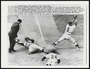 Infielder Harvey Kuenn of the San Francisco Giants slides safely into home plate, scoring on Jesus Alou's double to centerfield, during first inning of second game of doubleheader against the New York Mets in Shea Stadium here 5/31. Mets' catcher Chris Cannizzaro (8) waits for throw from centerfield. Umpire is Edward Sudel. Giants' team captain Willie Mays (24) squats in foreground. A crowd of 57,033 fans watches the Giants "steal" the opener, 5-3, to gain first win of series.