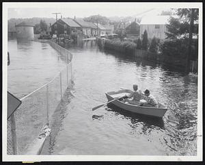 Hyde Park Flood Scene-Two unidentified boatmen row along Margin street ...