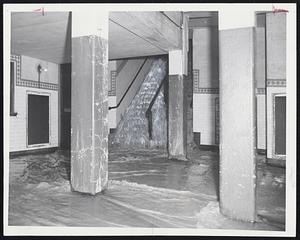 Traffic was Halted when a water main broke at the corner of Boston's Washington and Boylston Sts. At left, water from the break pours into an MTA subway station and, at right, passersby watch the muddy torrent race toward Kneeland St. It washed up over sidewalks and flooded many cellars.