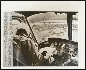 Coptor View of Flood Aftermath--This is how the flooded area around Shively, near Pepperwood, looks to a helicopter pilot as he flies mercy missions over the distressed Eel River area. The river, background, is again within its bank but water remains on farmland in foreground. Army Col. Raymond Evers of Centralia, Ill., follows course with fingers on map as he navigates this particular flight.