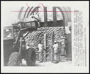 Hurricane Hazel Preparation. Workmen are busy here today sandbagging a power company's main generating plant near the Providence River as word was received that the season's eighth hurricane might strike the area tomorrow.