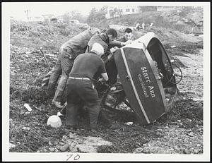 Casualty of Esther--Marbleheaders join in inspecting the bottom of this runabout, which broke loose from its mooring and was cast ashore by storm tides. Many boat owners had similar trouble as storm struck harbors.