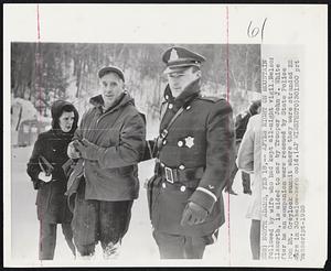 North Adams -- After Night On Mountain -- Followed by wife who had kept all-night vigil, Nelson Ellsworth, is aided to car by Trooper John J. White after he and companion were rescued by State Police from Mt. Greylock summit where they were stranded 22 hours in 33-below-zero cold.