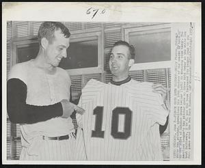 Pierce Gets 10th Victory--Billy Pierce, Chicago White Sox pitcher, symbolizes his 10th victory of the season by holding up the shirt of Catcher Sherm Lollar (left) in dressing room today. The American League's top pitcher gave up three hits today as the White Sox beat Baltimore, 2 to 0, and the team increased its league lead to six full games over the New York Yankees.