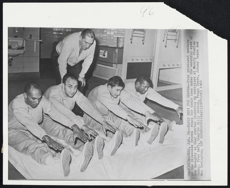 Milwaukee – Early Oof! For Braves – Four prominent members of the Milwaukee Braves reach for their toes under the watchful eyes of Ben Geraghty as they started limbering up exercises at County Stadium today. From left, they’re Billy Bruton, Frank Torre, Johnny Logan and Wes Covington.