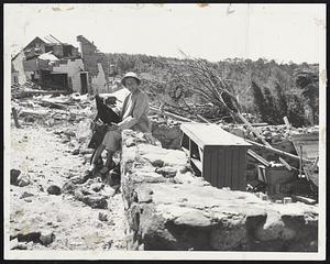 A Smile In Spite Of It All is mustered by Mrs. Bernice Wood at the site of her destroyed home on South Main St., Holden. Her spirit is reflected among the hundreds of residents of the storm region who are already making plans for reconstruction.