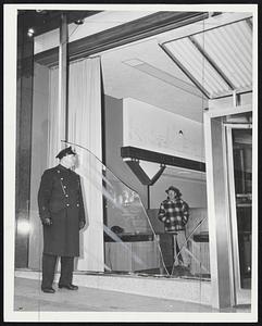 Fierce Gales and icy weather hit New England yesterday, causing heavy damage. Center, smashed window of Boston Five Cents Savings Bank, Tremont and Winter streets, Officer Daniel Hurley on guard.