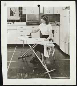 Sit Down and relax while you're ironing. A new-type iron eliminates lifting the equivalent of two and a half tons in an average ironing day, it's estimated. Simply press a button and the iron sits up on end; press the back handle and it returns to the ironing position.