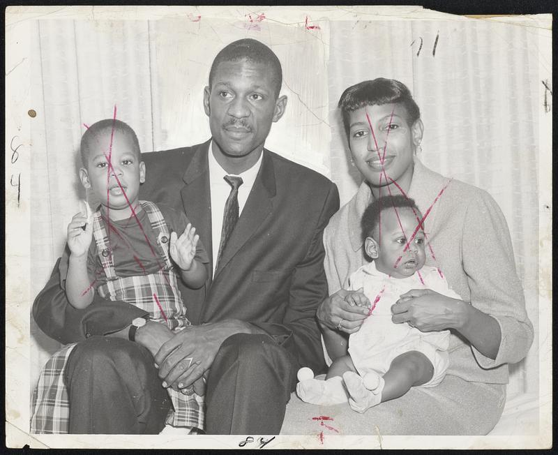 Good Luck, Daddy-Wishing Celtic star Bill Russell best on his trip to St. Louis for game with Hawks tonight are members of his family, Bill, Jr., perched on his Dad's lap, and wife Rose, holding son, Harold Jacob.