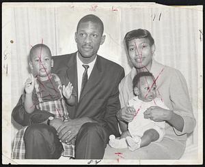 Good Luck, Daddy-Wishing Celtic star Bill Russell best on his trip to St. Louis for game with Hawks tonight are members of his family, Bill, Jr., perched on his Dad's lap, and wife Rose, holding son, Harold Jacob.