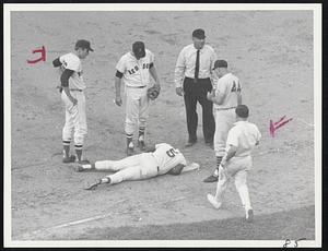 Aftermath of Collision -- George Scott lies across first base after tagging bag with hand to make putout on Dick Nen in Fenway twilight game. He was inadvertently kicked by runner. From left- Jerry Stephenson, Mike Andrews, umpire Hank Soar, Nats' Joe Pignatano, trainer Buddy LeRoux.