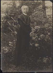 Woman standing among flowers