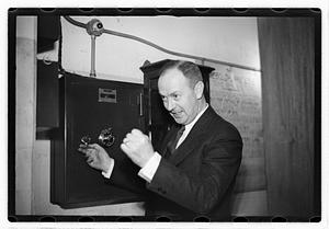 A man demonstrating how to break into a safe