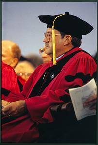 Cambridge, MA Harvard U 1993: A dean on the stage listens to a speaker at commencement