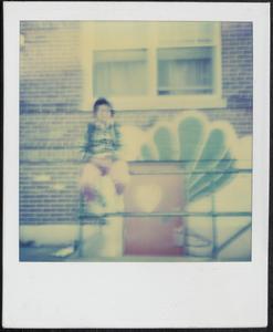 Person sitting on metal railing