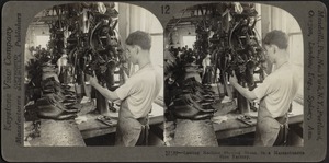 Lasting machine shaping shoes, in a Massachusetts shoe factory, Lynn, Mass.