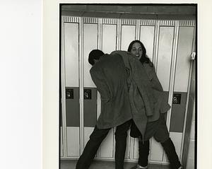 Two students clowning by the hall lockers