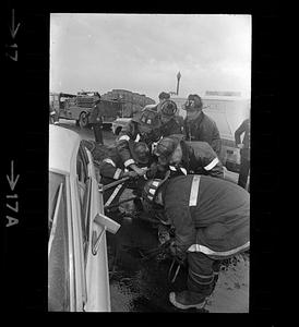 Firemen pry open door of car after accident, Jamaicaway
