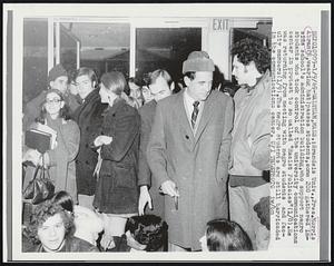 Brandeis Univ,., Pres. Morris Abram (R, wearing hat) passes students, some 200 gathered inside school's administration building, who support negro students who took control of the university communications center in protest to so called "Racist Policies" (1/8). He was returning from meeting with negro students and faculty members (1/9). The negro students are still barricaded in the communications center.