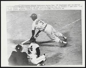 Floyd Robinson, White Sox RF flattens out on inside pitch by Wally Bunker, Birds P in 4th inning. Charlie Lau is Oriole C and John Rice home plate umpire.