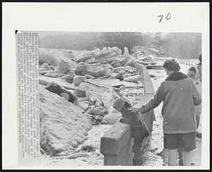 Ice Increases Flood Peril-Huge chunks of Mississippi River ice jam against a small bridge at a bend in the big stream 15 miles north of St. Cloud. The bridge crosses the mouth of a small tributary. Similar jams in the Mississippi and other flooding Minnesota streams have aggravated flood conditions. Woman spectator extends a protective hand as a youngster peers into the swirling ice-choked water.