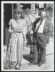 Don Carr - mgr - F.W. Woolworth - Wollaston Branch. President Wollaston Businessmens’ Association - gets an reducing idea as customer, Mrs Betty Stowell 119 Pine St, Wollaston leaves his store with hula hoops