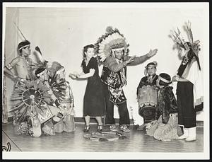 Chief White Horse does Boomps-A-Daisy with Vera Chapin, Boston dancing teacher as Hopi Indian dancers from Arizona look on.