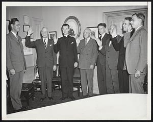 Swears in Trustees. Gov. Maurice J. Tobin of Massachusetts swears in seven college presidents who have been appointed to the Board of Trustees of Massachusetts State College to direct the college extension for veterans at Fort Devens, Mass., tonight (June 26) at the Parker House. Left to right: Tobin, admiral W. T. Cluverius, President of Worcester Polytechnic Institute; Rev. William L. Kelleher, S.J., President of Boston College; Dr. Carl S. Ell, President of Northeastern University; Dr. Charles W. Cole, President of Amherst College; Dr. Daniel J. Marsh. President of Boston Univ: Rev. William Healy, S.J., President of Holy Cross College; and Dr. James B. Conant, President of Harvard University.