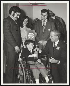 Contribution for the second annual "Shamrocks for Dystrophy" campaign is made by Mayor Kevin White to Kevin Rull of Mattapan, Poster child of the Greater Boston Muscular Dystrophy Assn. With them are Suffolk University students Charles George. Pam Clark and Robert Cardillo Jr.