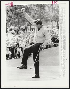 Dandy Doug Sanders, dressed in bright green sweater and dark green trousers, whoops it up on the second green after sinking a long birdie putt to begin his charge for a hoped-for Masters title. Action came in third round of play 4/9.