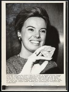 Glints From the "Light of Peace"--Natalie Baumer holds the "Light of Peace," a 434.6-carat diamond when it was unveiled in New York Wednesday by its purchaser, a large retail jewelry chain. Officials of the Dallas-based Zale Corp., the purchaser, said the stone was dubbed the "Light of Peace" because it will be used to promote peace. It is the 14th largest uncut diamond ever discovered.