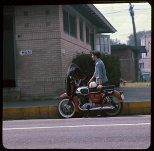 A man next to a motorcycle