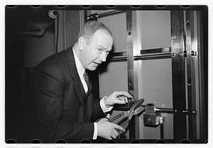 A man demonstrating how to break into a safe