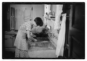 Woman doing laundry at a sink
