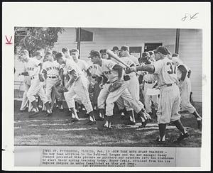 New York Mets Start Training - The new team addition to the National League and the new manager Casey Stengel presented this picture as pitchers and catchers left the clubhouse to start their spring training today. Roger Craig, obtained from the Los Angeles Dodgers is under Casey's bat as they get away.
