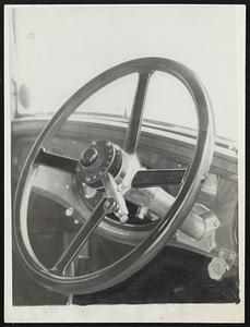 Self-Shifting Gear. No more grinding of gears now that the self-shifting gears have been perfected. Photo shows the steering wheel control on the auto. Changes take effect when pedal in depressed. They are now in use in London, England.
