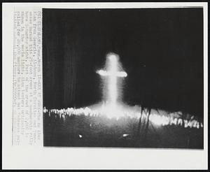 KKK at Work-The Ku Klux Klan from Georgia, Alabama, North Carolina and Tennessee burned this 25-foot cross at a membership rally here Saturday night. Part of the crowd of 2,000 is shown in the eerie light. Klan leaders originally called for 20,000 members to attend but “adverse publicity” reduced the figure.